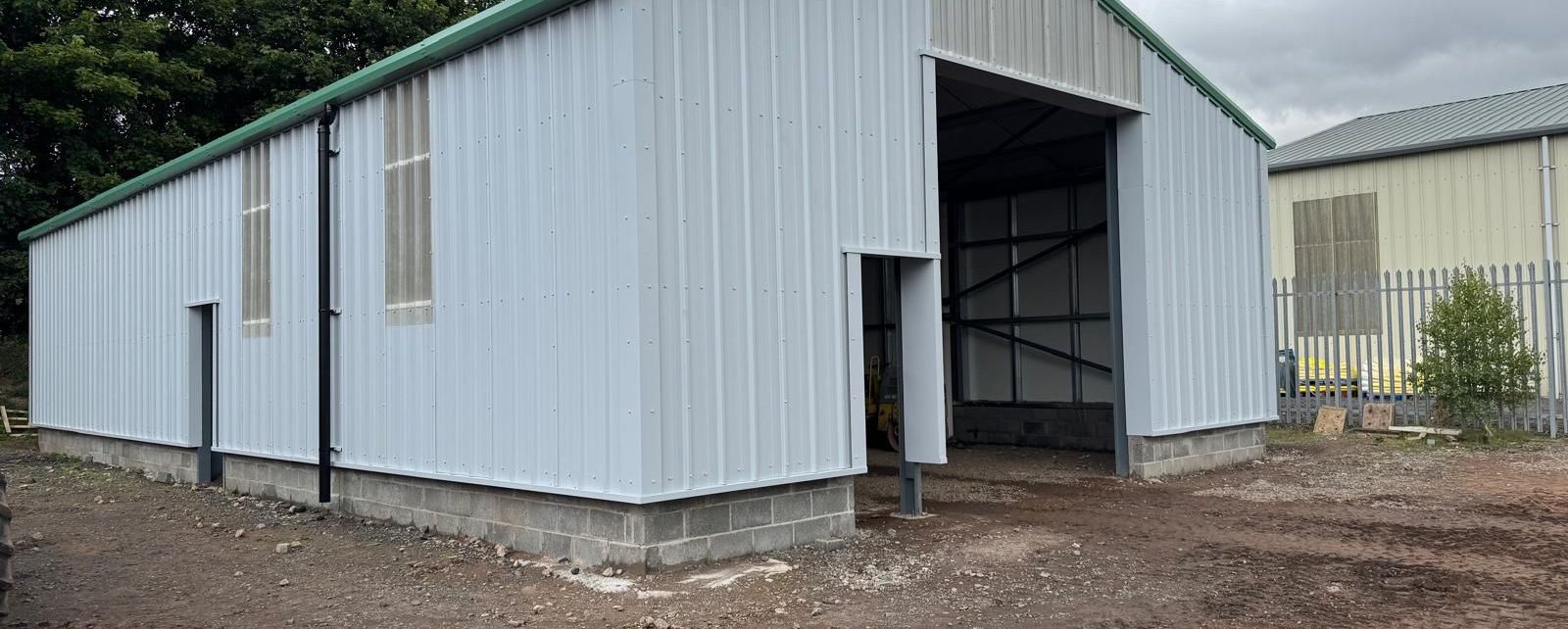 White and green steel building